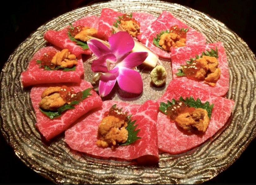 Signature dish “Lean Ozaki beef sashimi topped with sea urchin and salmon roe”